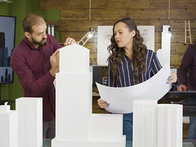 Professional architects & civil engineers studying building layouts in Ahmedabad.